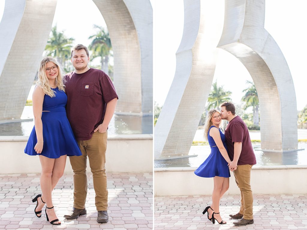 Couple smiling by the fountain for graduation pictures.