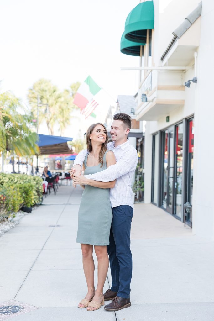 Couple standing by the shops in St. Armands Circle in Sarasota, Florida. 