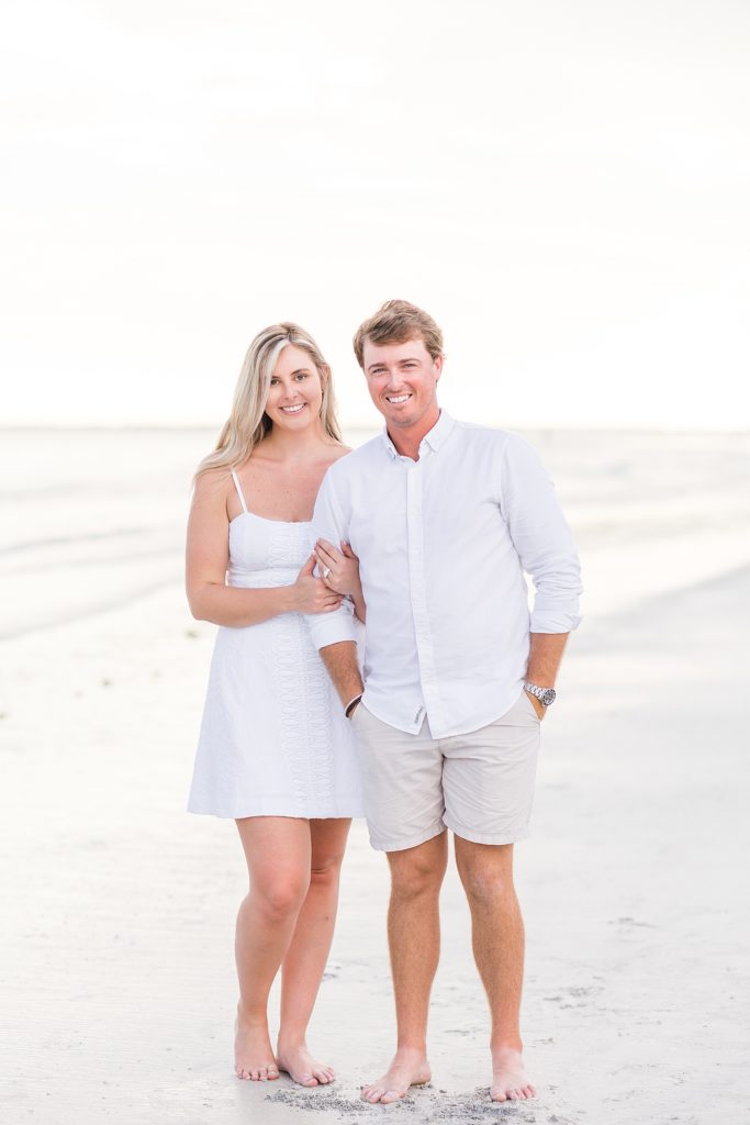 A couple smiling during sunset at their Fort Myers Beach Engagement Session. 