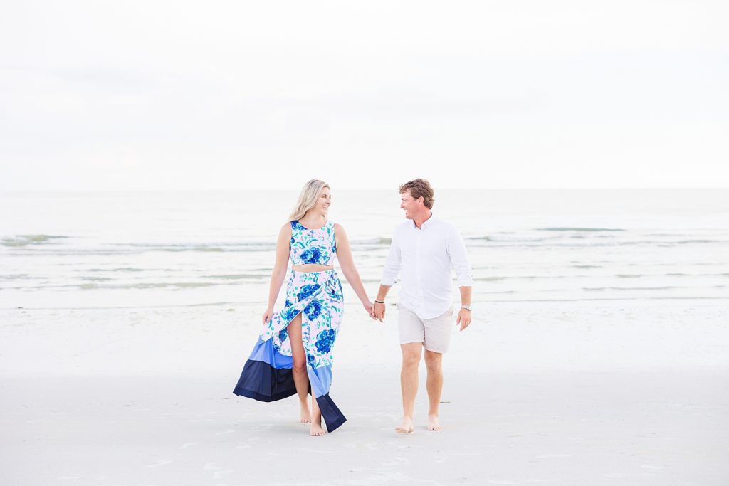 A couple walking during their Fort Myers Beach Engagement Session. 
