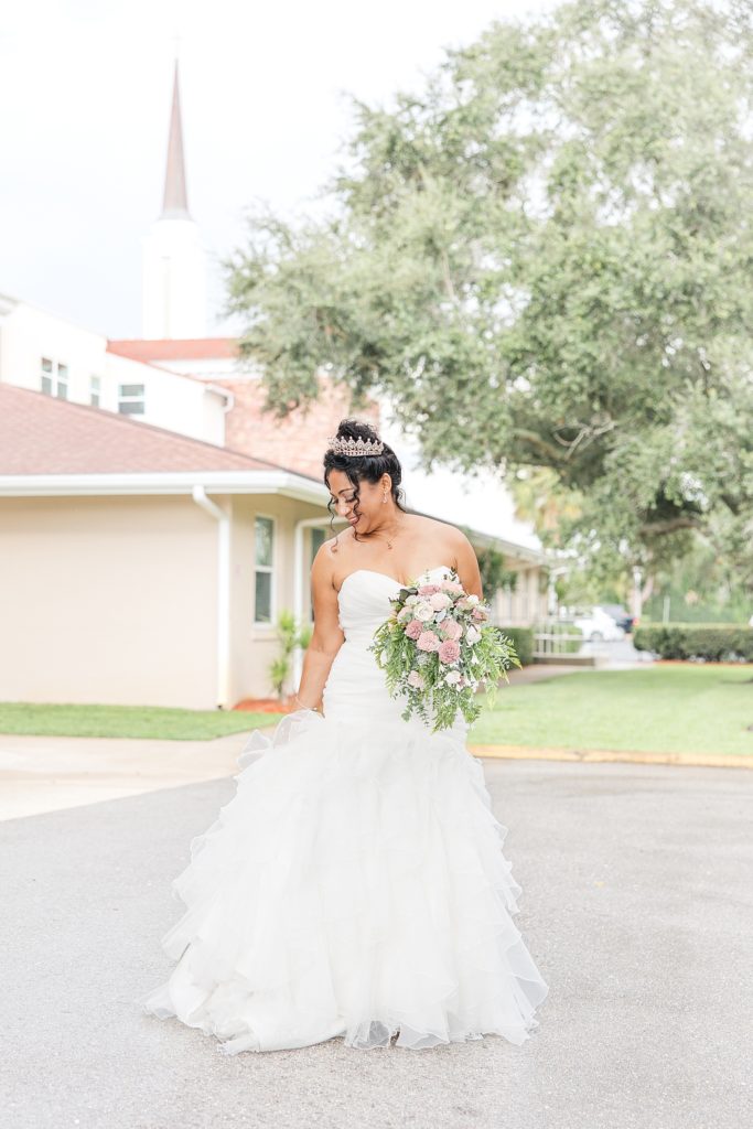 A bride outside of the West Bradenton Church in her wedding dress. 