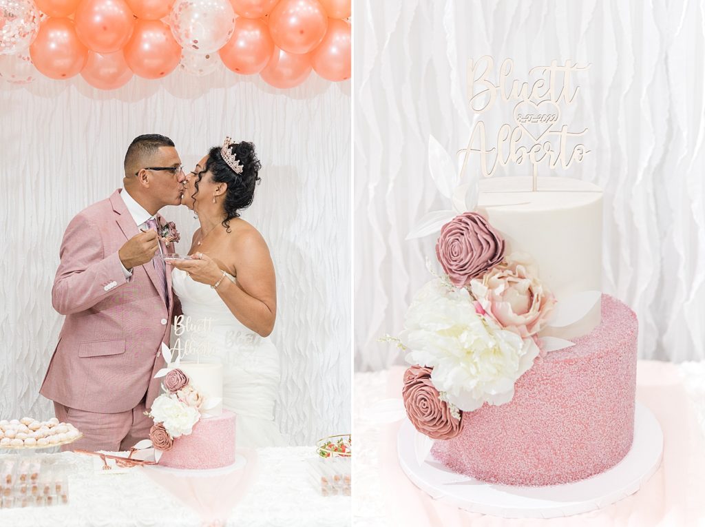 A bride and groom kissing after cutting their pink wedding cake. 