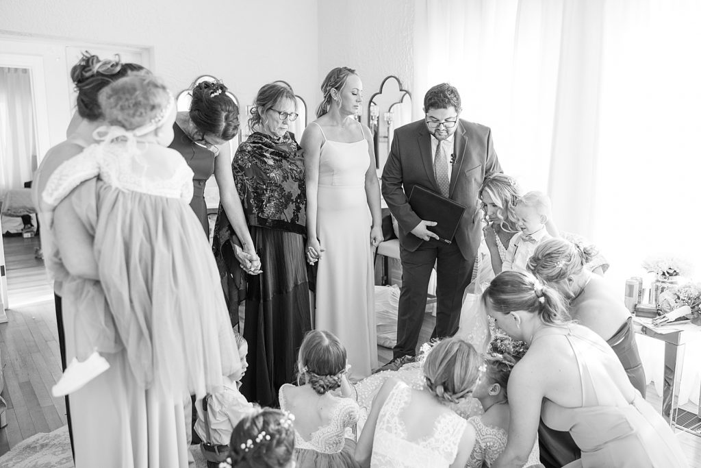 Bridal party praying together before the wedding ceremony. 