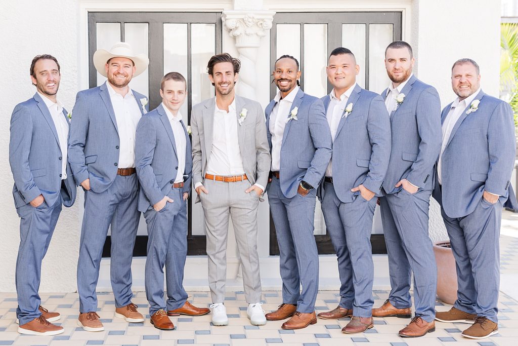 The groom and groomsmen smiling together at the alderman house by mizner.