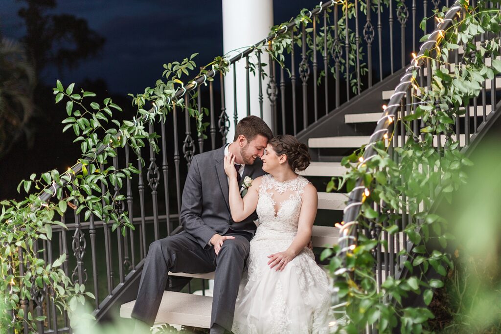 bride and groom sitting on the staircase at Lakewood Ranch Golf and Country Club