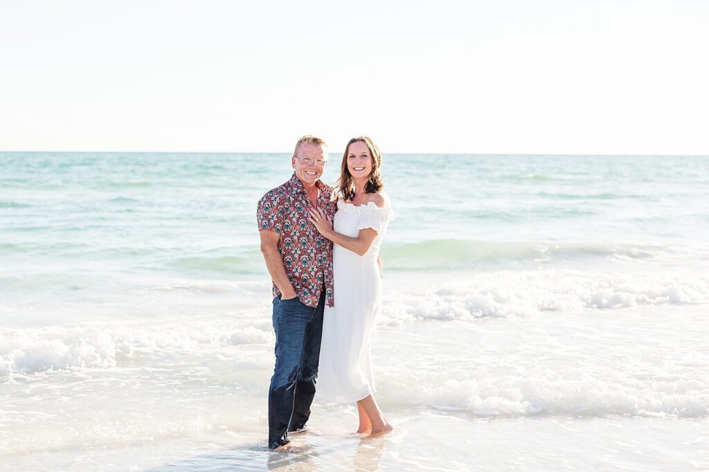 couple standing in the water at siesta key beach