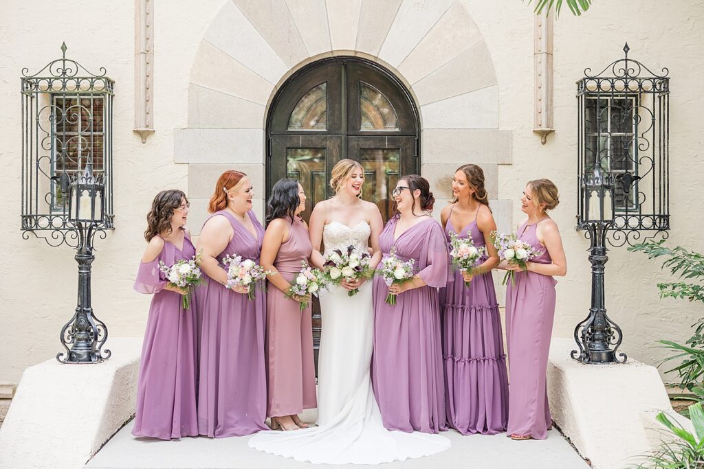 Bridesmaids wearing purple dresses