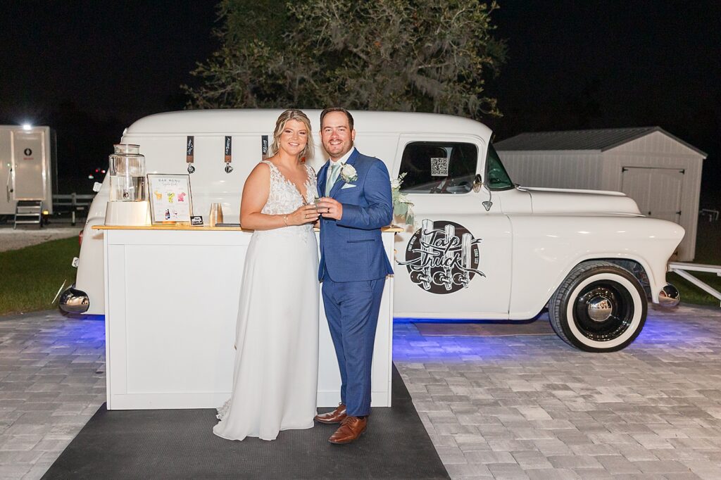 Bride and Groom smiling with the Fort Myers Tap Truck. 