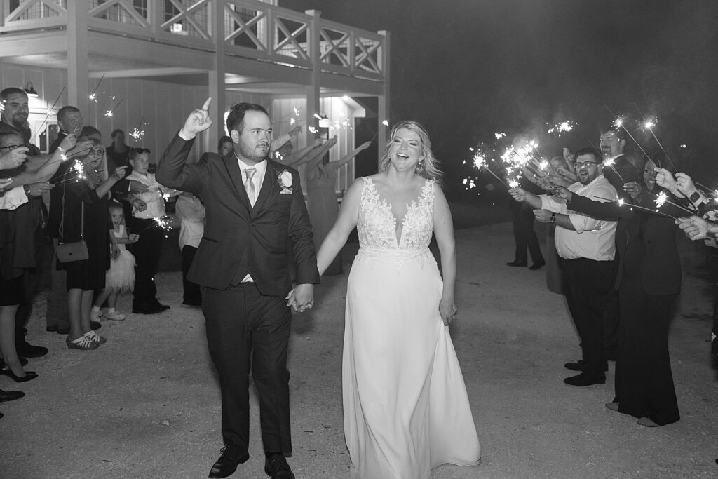 Black and white picture of a sparkler wedding exit. 