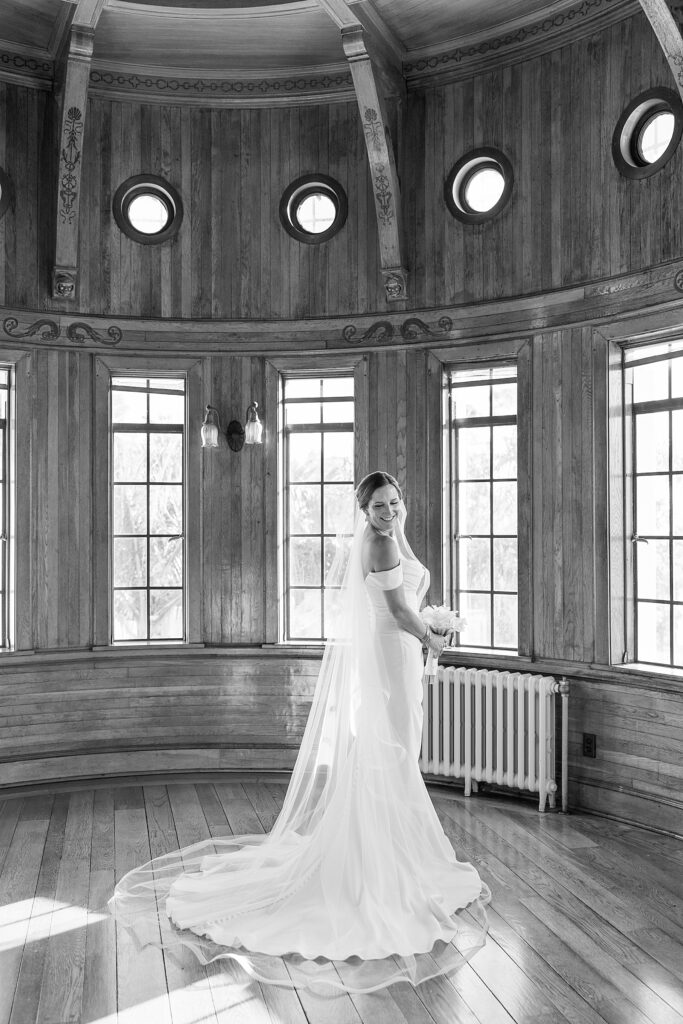 Black and white picture of the bride in the Ship Room at the Seagate Powel Crosley Estate. 