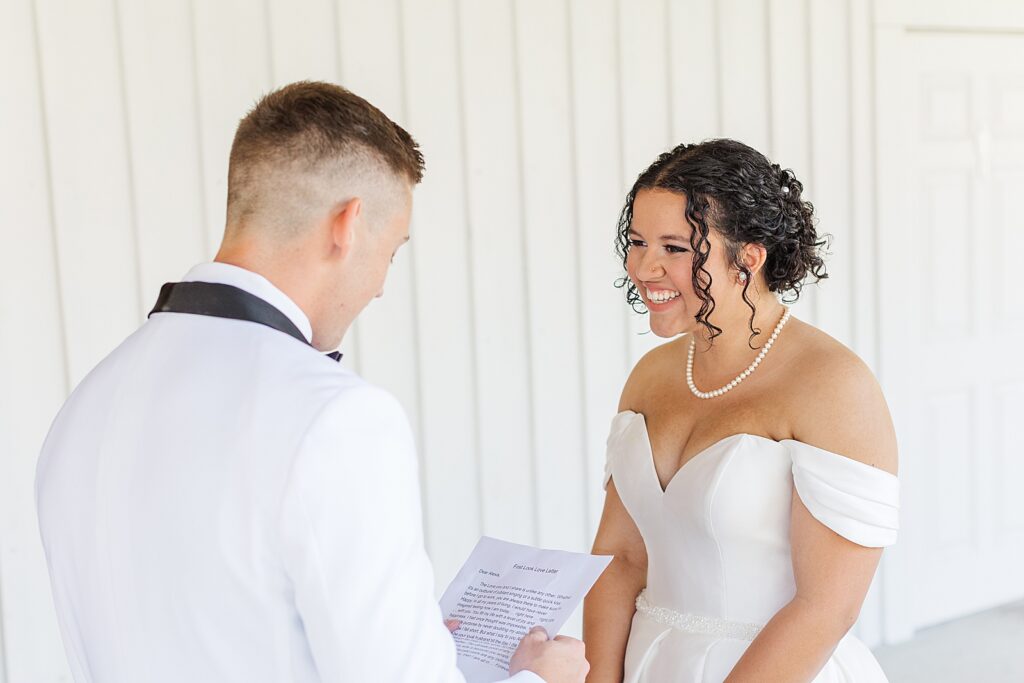 Bride and groom reading private letters to one another. 