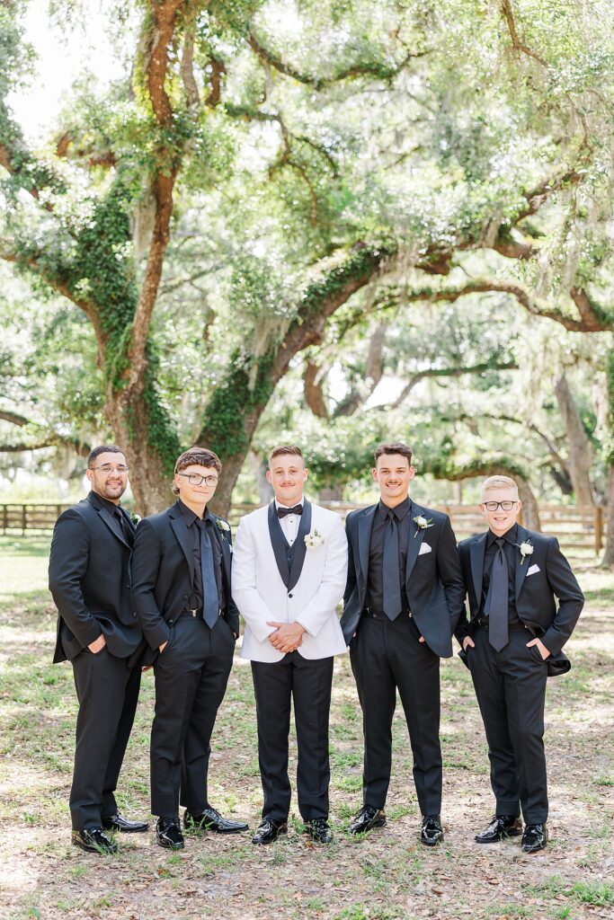 The groom and groomsmen smiling. 