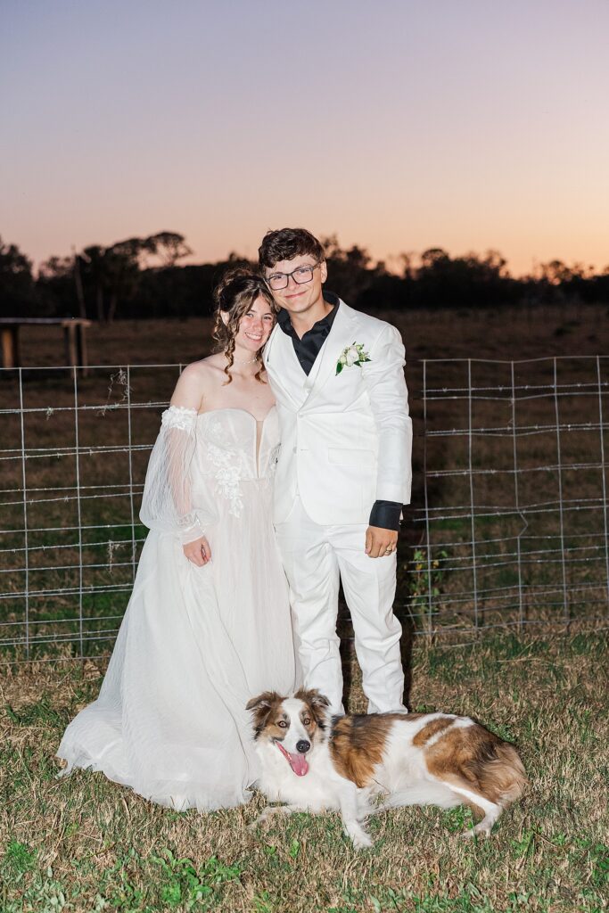 Bride and groom with their dog. 