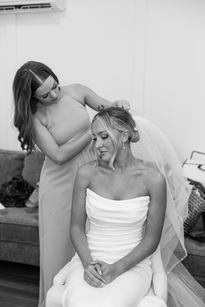 Bride putting on her veil.