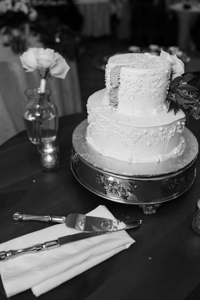Black and white picture of the cut wedding cake.