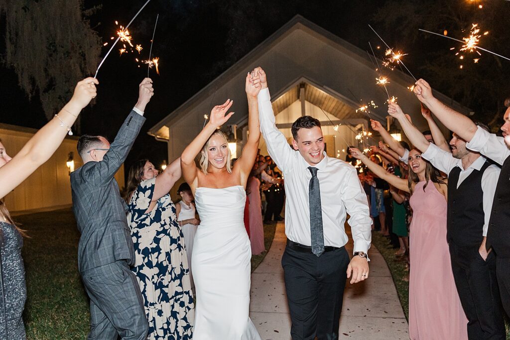 Bride and Groom cheering in a sparkler exit at The Hudson Manor
