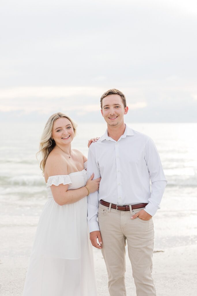 couple on st. pete beach smiling at the camera