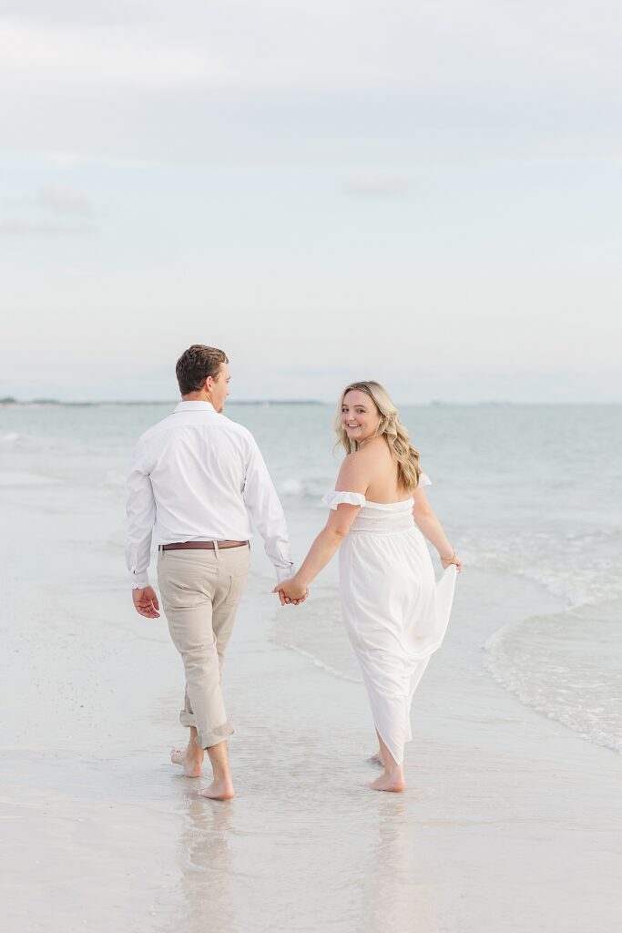 couple walking along the water at St Pete beach