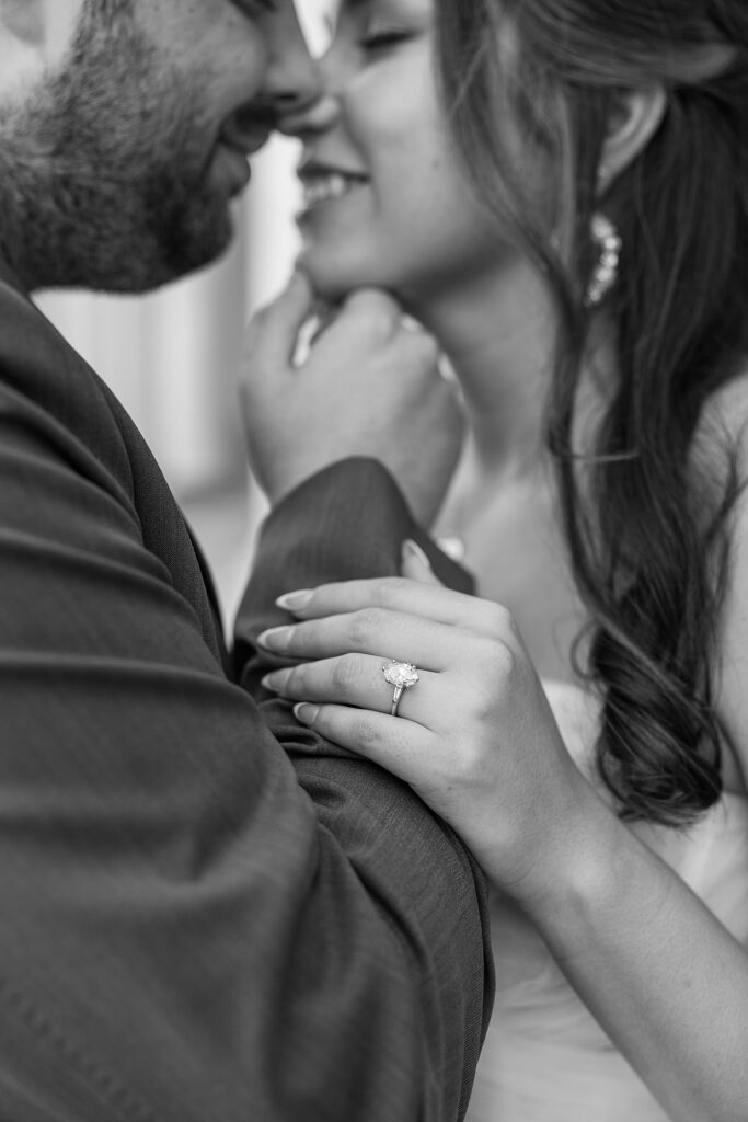 black and white picture of the bride and groom about to kiss