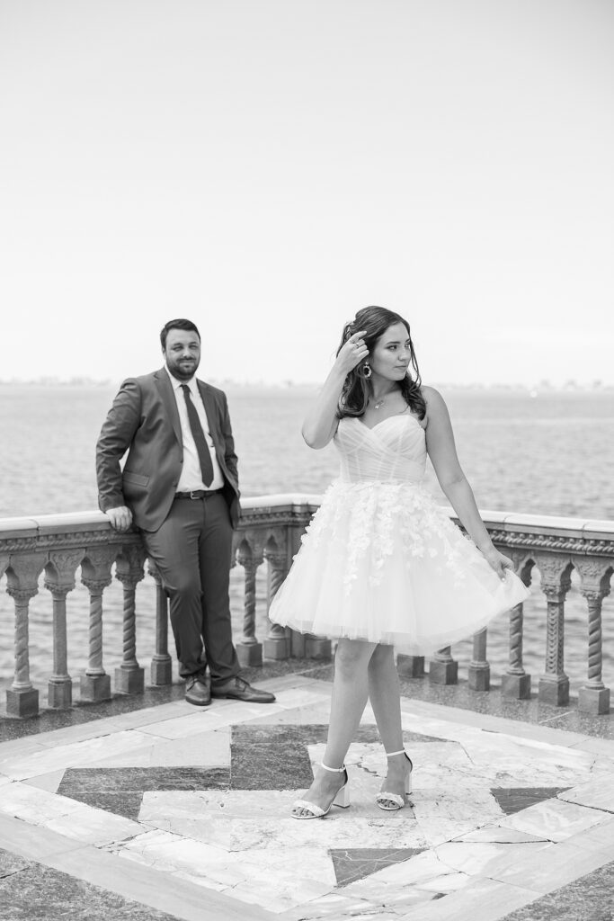 black and white photo of the bride looking off in the distance and the groom is looking at her