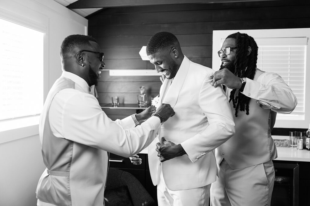 black and white photo of the groom getting ready. 